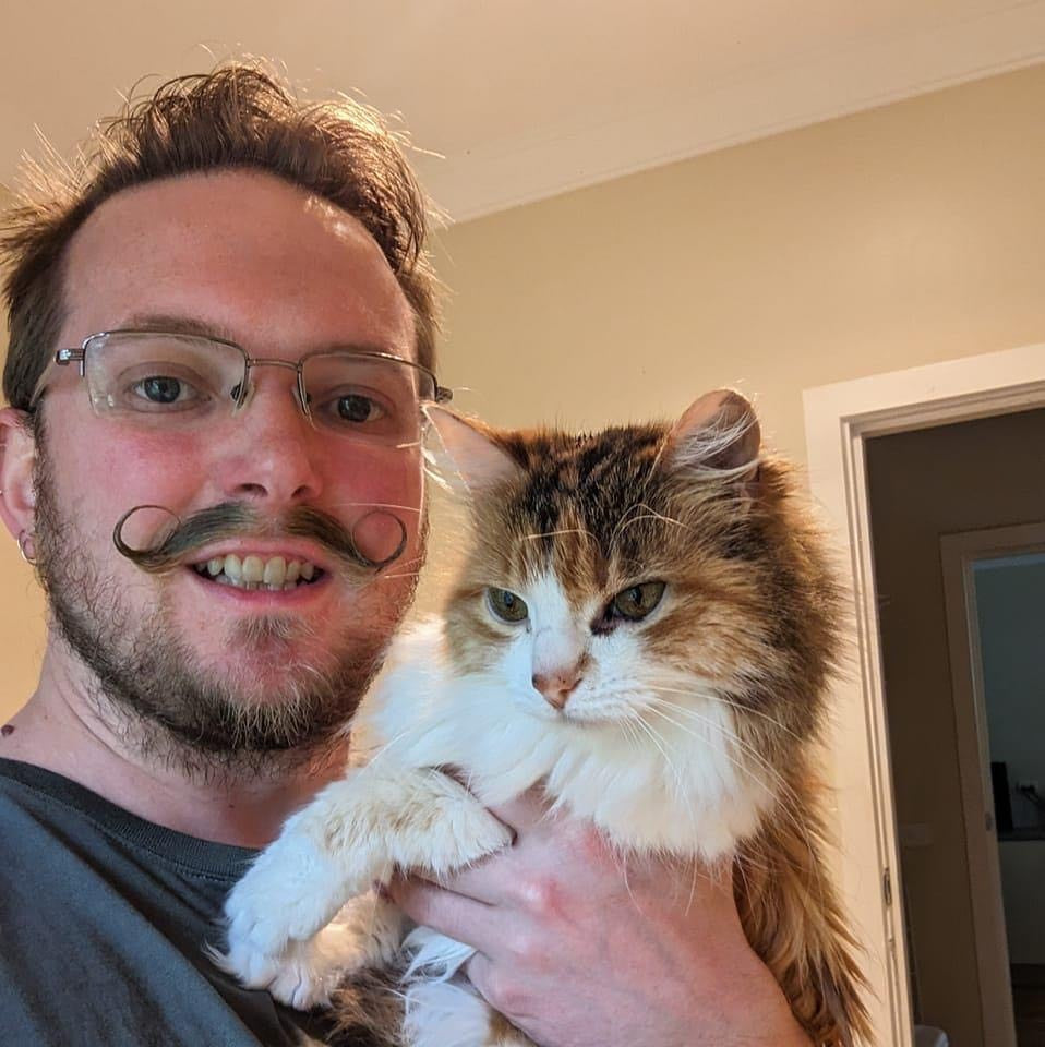 Justin Mercer - The Handlebar Stitcher holding his cat