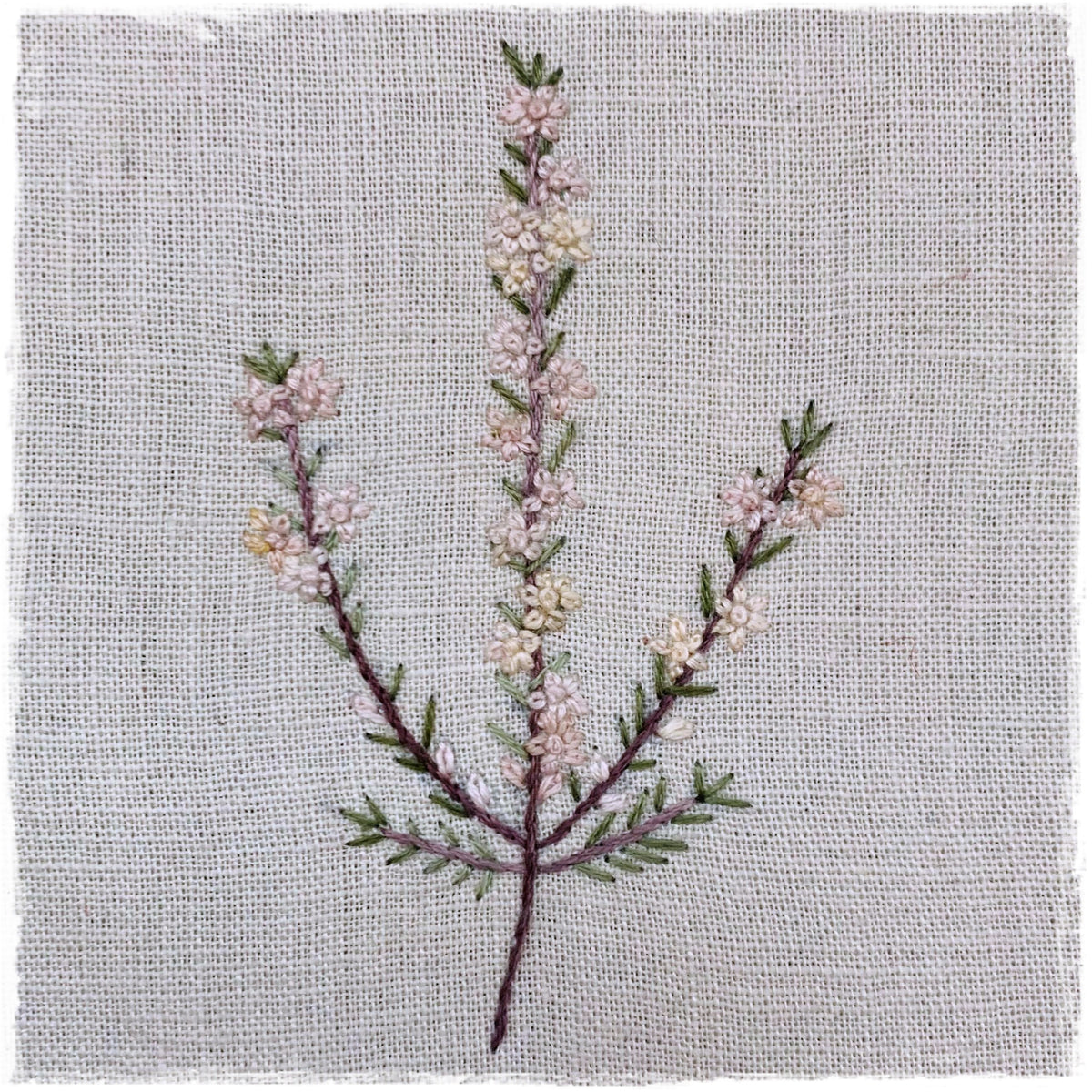 needlecraft pattern for a field journal quilt, featuring a stitched design of a plant with a branch and leaves on a linen background.
