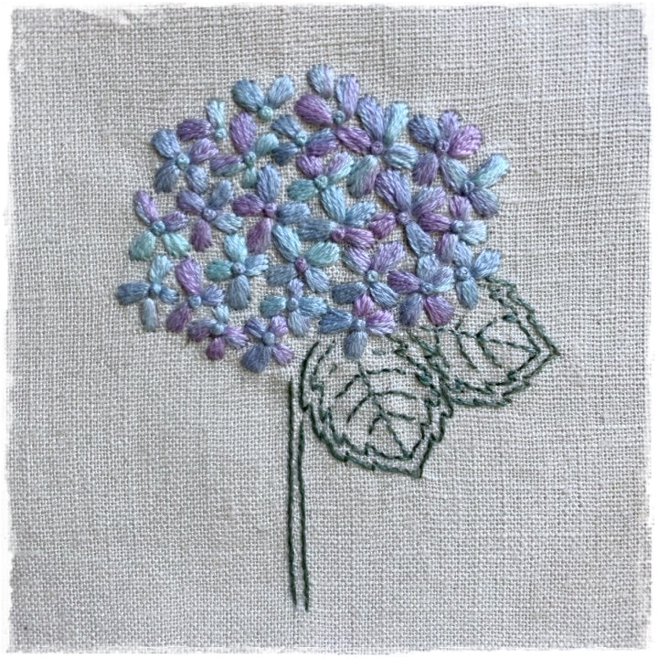 needlecraft pattern for a fabric craft, featuring a stylized floral design with multiple colors