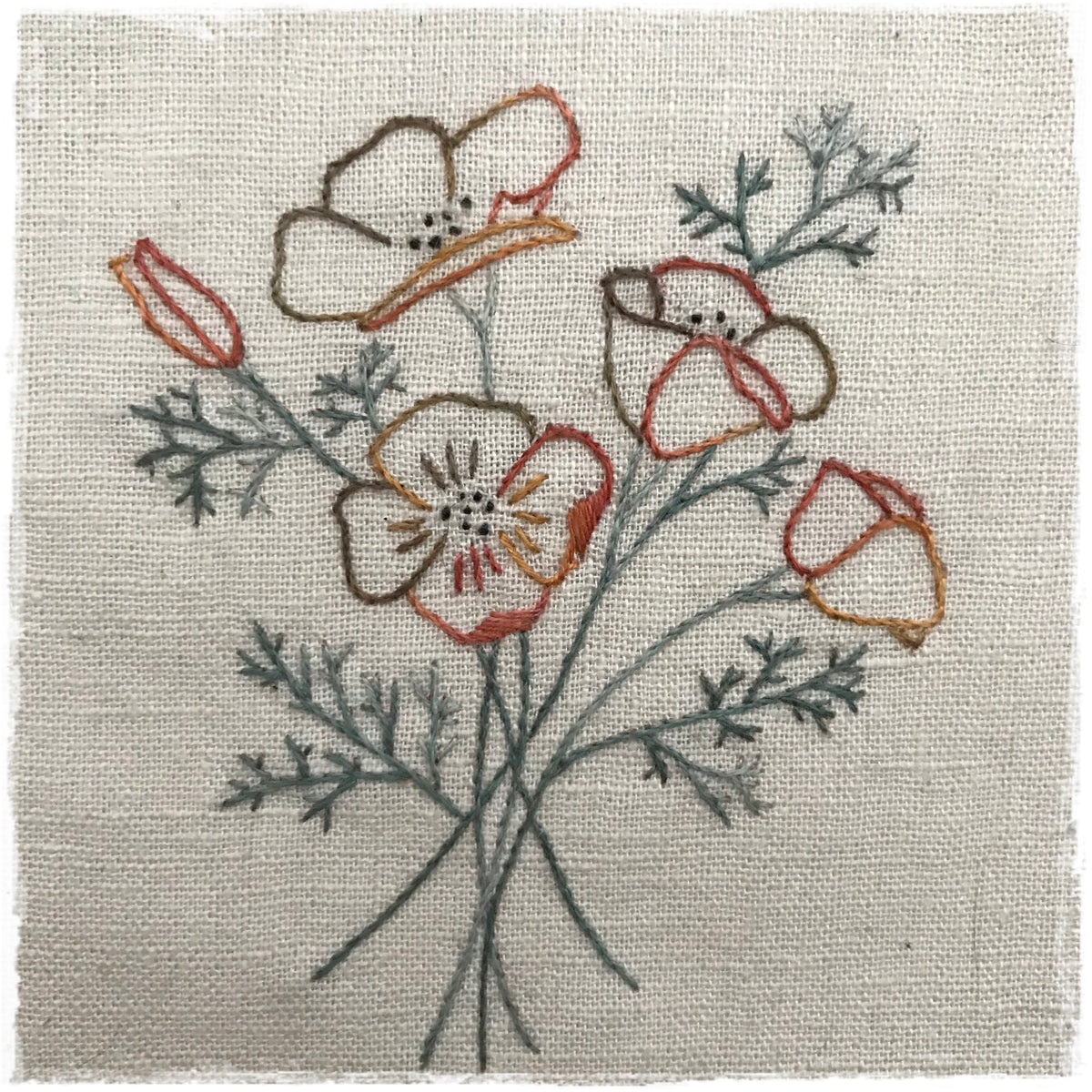 needlecraft pattern featuring a stylized floral design with red, blue, and green colors on a beige background