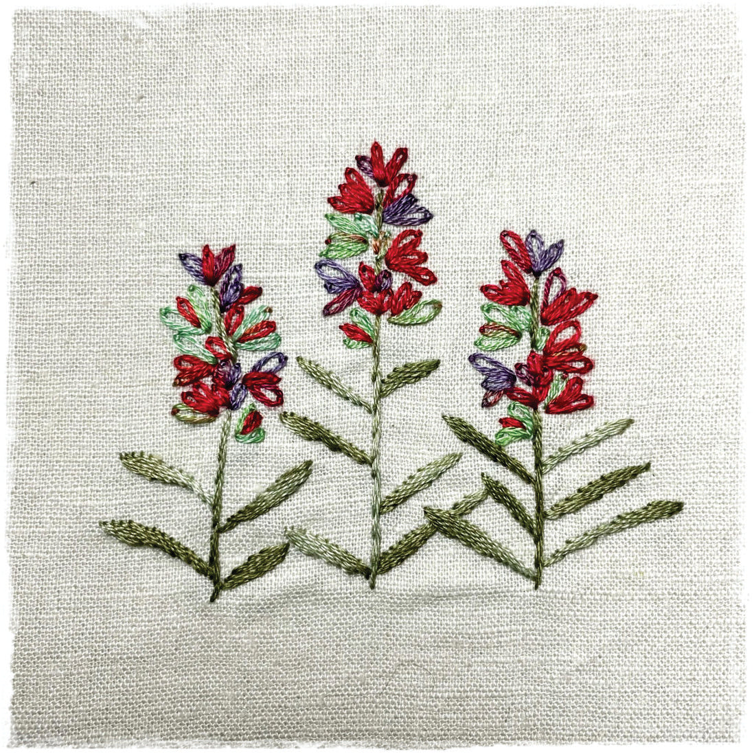 needlecraft pattern featuring a quilted design with red and blue flowers on a beige background, labeled as &