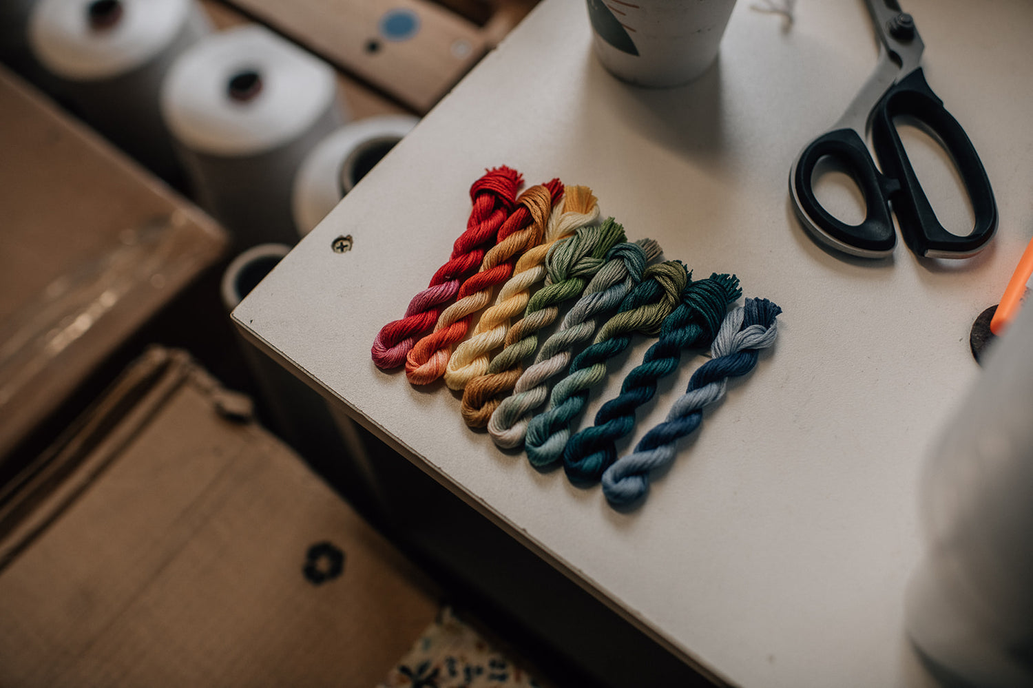 Eight twisted threads photographed in a row on a table