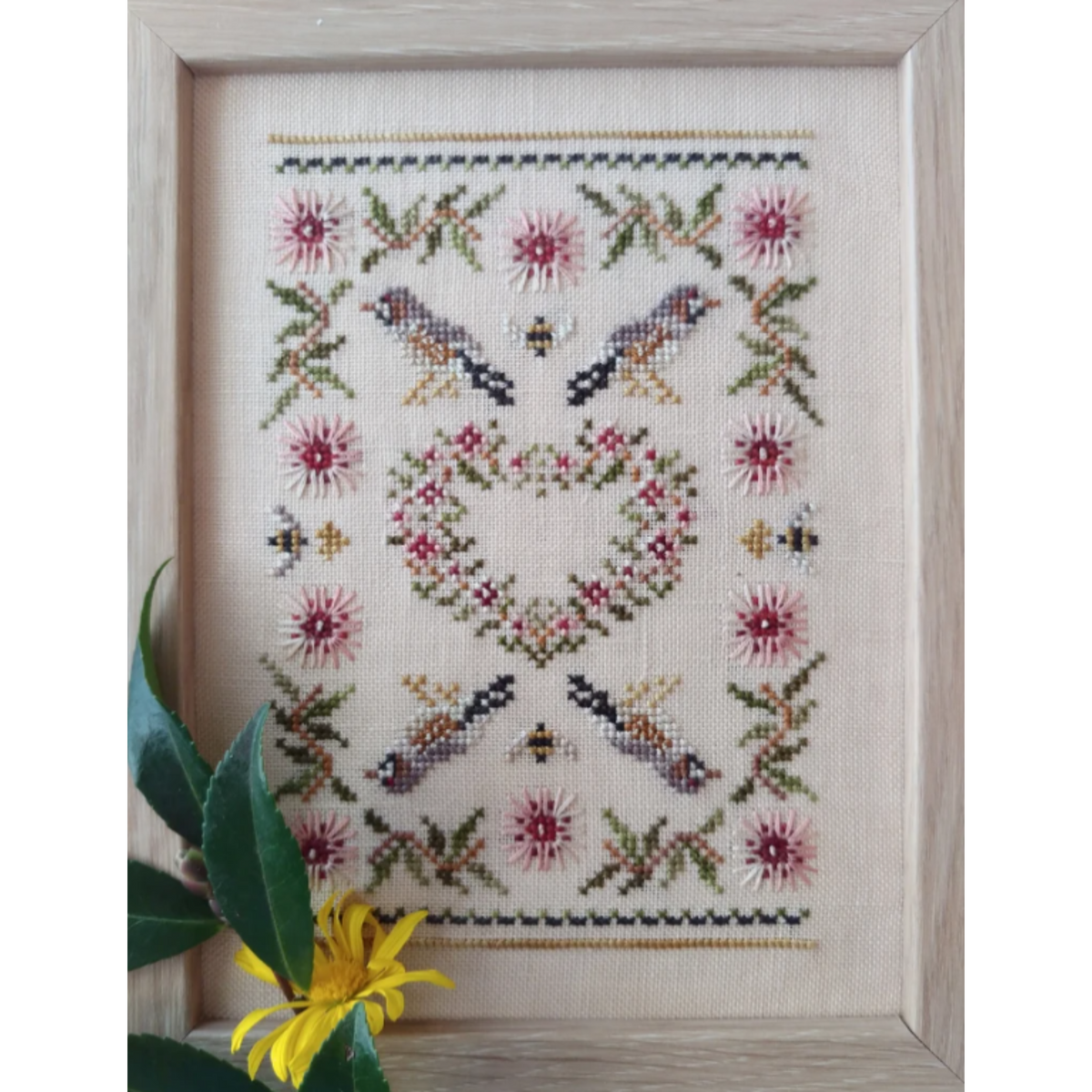 Cross stitch kit depicting a Hakea flower and Zebra Finch design, stitched on a linen fabric with floss and thread.