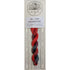 A packaged skein of yarn on a white card. The yarn is variegated in shades of red, orange, and dark gray/blue, resembling cranberry.