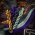 Four twisted embroidery threads in burnt orange, grey, bright purple and dusty green.
