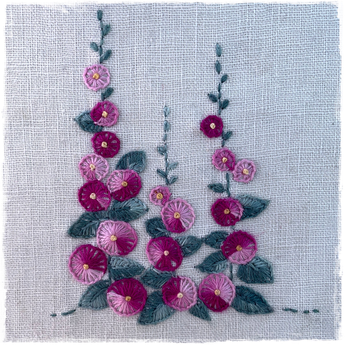 quilted fabric featuring a floral design with pink and purple flowers and green leaves on a linen background