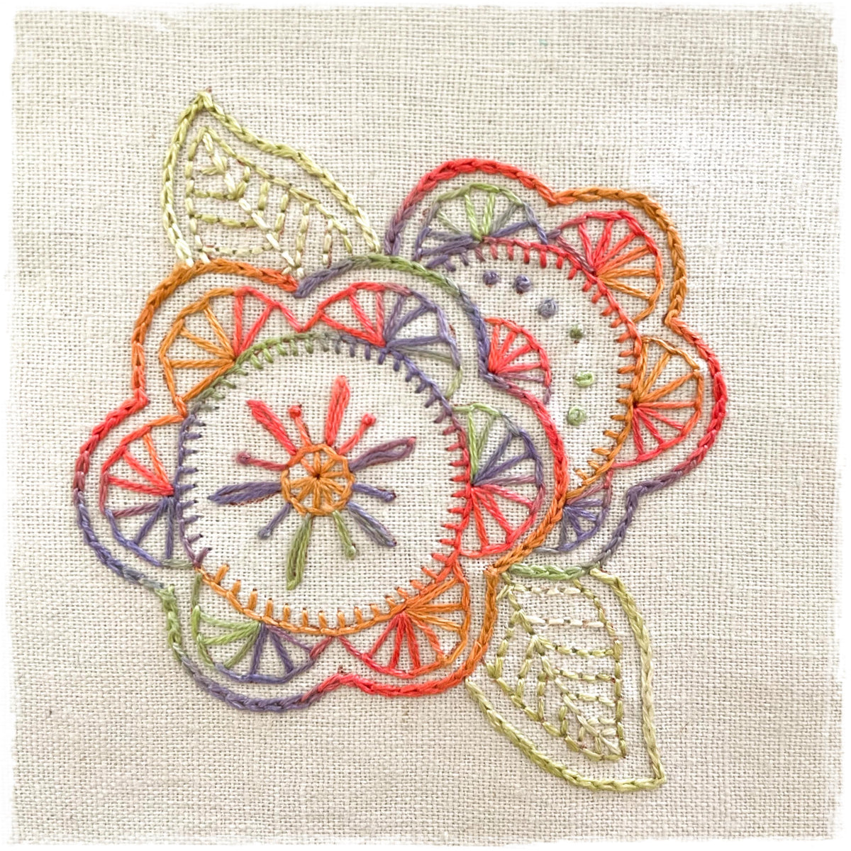 hand-stitched journal page with a floral design, featuring multiple colors.