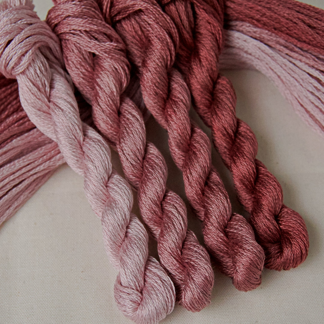 An embroidery thread gradient pack in the colour Mulberry, with shades from pale to dark. From Cottage Garden Threads.
