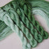 Four twisted skeins of embroidery thread from icy green to cool dark green tones.