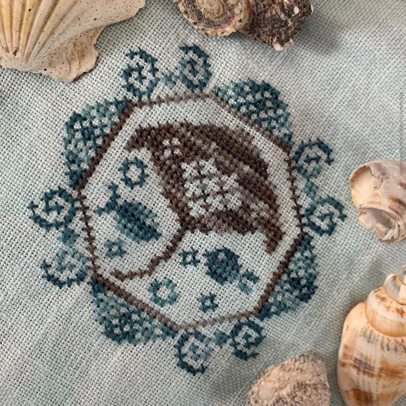a cross-stitch pattern of a brown and white fish design